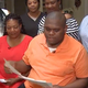 Micheal Brown, rifling through his college acceptance letters. He says he was inspired by his mother (left) whom he saw work hard to get a community college degree when he was a child.